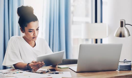 Female with tablet and laptop